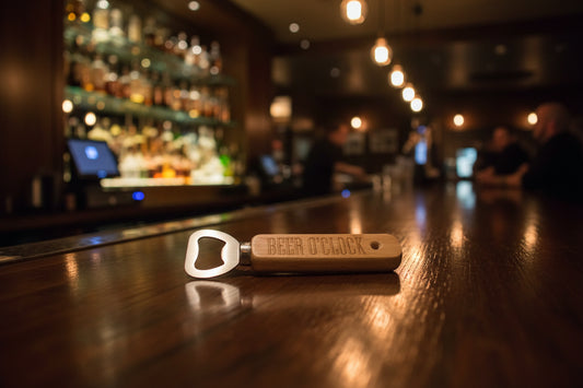 Wooden bottle opener with 'BEER O'CLOCK' engraving on a wooden surface